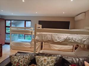 a living room with bunk beds and a couch at Vaal River Front Lodge in Sasolburg +63 photos