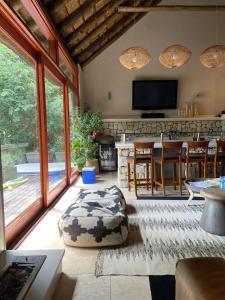 a living room with a kitchen with a table and a couch at Vaal River Front Lodge in Sasolburg