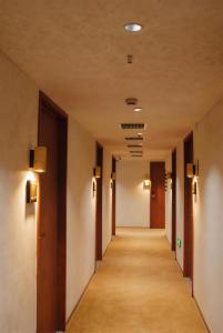 a corridor in a building with lights on the ceilings at 無桐Mini酒店WowTown in Shanghai +34 photos