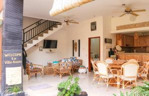 a living room with a table and chairs at Villa Aniela Legian in Legian