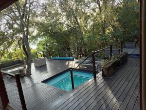 a deck with a swimming pool on top of a house at Vaal River Front Lodge in Sasolburg