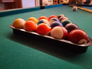 a pool table with a tray of balls on it at Hochtal Apartments in Tannheim +52 photos