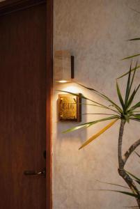 a light on a wall next to a door at 無桐Mini酒店WowTown in Shanghai
