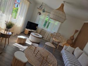a living room with a couch and chairs and a tv at Casa Lumina in Lachapelle-sous-Rougemont