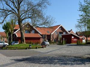 a large house with cars parked in front of it at Sielhof Ditzum 45263 in Ditzum