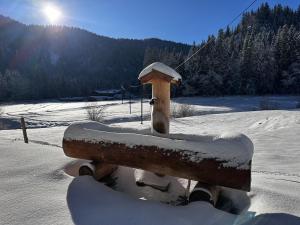 a snow covered bench in a snow covered field at Mitteralm-Kreuth in Kreuth +56 photos