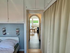 a bedroom with a bed and a hallway at Haus Lith - Ferienwohnung Strandläufer in Nordstrand