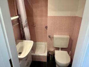 a bathroom with a white toilet and a sink at Haus Lith - Ferienwohnung Strandläufer in Nordstrand