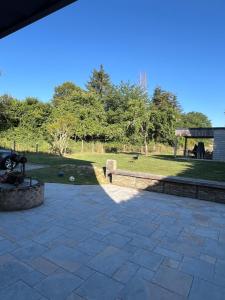 a patio with a fire pit and a park at Chez Paulette - par Happy House in Gouzon
