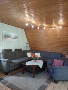 a living room with two couches and a coffee table at Nordseenest in Butjadingen +12 photos