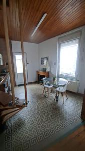 a living room with a table and a glass table at Maison Aux Cailloux in Calais