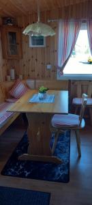 a room with a table and a bed and a table and chairs at Mysan in Glommersträsk