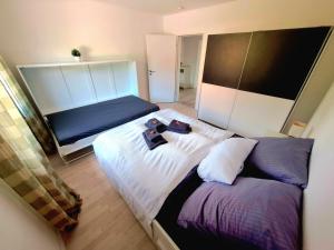 a bedroom with a large bed with towels on it at Apartment Weißer Burgunder in Bad Sachsa