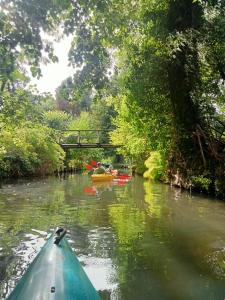 a group of people kayaking down a river at Spreewald-Pension Marina in Lübben