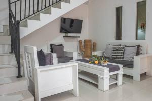 a living room with a couch and a table at Villa Mali Legian in Legian