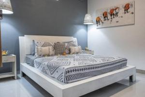 a bedroom with a bed with a zebra print bedspread at Villa Mali Legian in Legian +17 photos