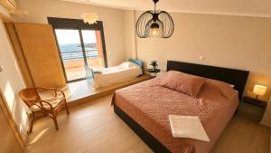 a bedroom with a bed and a view of the ocean at Alia Beachfront Penthouse with Sea View in Lefkandi Chalkidas