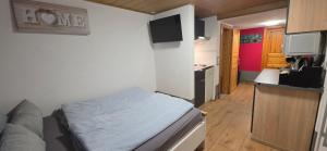 a small room with a bed and a kitchen at Nikolaus EG in Bernkastel-Kues