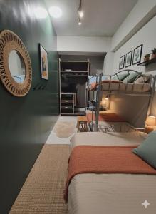 a bedroom with two bunk beds and a mirror at Ortigas Uptown Bonifacio CBD Hostel in Sampong +16 photos
