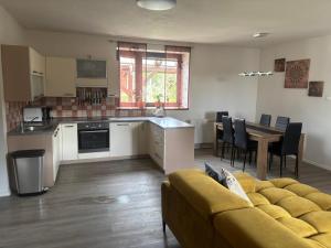 a kitchen and living room with a couch and a table at Pohoda ve Starých Bukách in Staré Buky