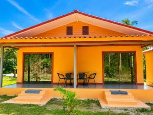an orange house with a patio at The Sun homestay03 in Ko Kut