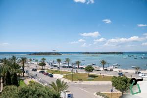 a view of a beach with boats in the water at Hotiday Porto Cesareo Spiaggia in Porto Cesareo