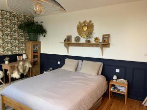 a bedroom with a bed with a blue accent wall at Bienvenue au 24 in Le Havre