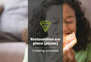 a young girl eating a slice of pizza at B&B HOTEL Marseille Bonneveine in Marseille