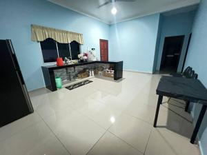 a blue room with a counter and a table at Homestay Abah in Bidur