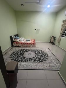 a room with a bed and a rug on the floor at Homestay Abah in Bidur +2 photos