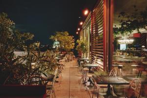 a row of tables and chairs outside a restaurant at night at Grand Ferdinand Vienna – Your Hotel In The City Center in Vienna