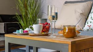 a table with food and a glass of wine on it at Six Corners Garden Corner with Terrace and Parking in Pécs +10 photos