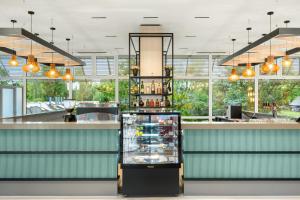 a restaurant with a counter with a bar at Danubius Hotel Annabella in Balatonfüred