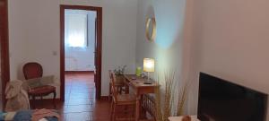 a living room with a table and a television at Garro1 in Pasajes Ancho