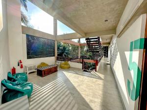 a living room with a staircase and a large window at Linará in Hikkaduwa