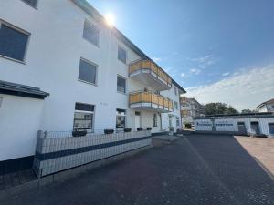 a white building with balconies on the side of it at Ferienwohnung Quartier18-09 strandnah in Karlshagen