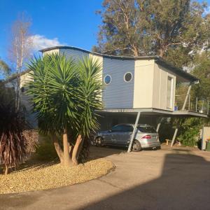 a house with a car parked in front of it at Unit 4 The village light house in Metung