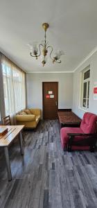 a living room with a couch and a table at Budget Hostel in Mestia in Mestia