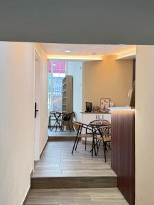 a hallway with a table and chairs and a kitchen at EDEAN Apartments 4 in Tirana