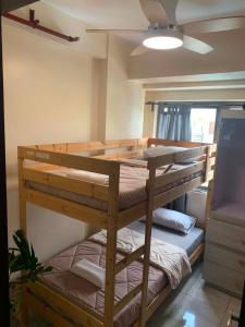 a bedroom with two bunk beds in a room at The Pine Lush Hideout in Baguio