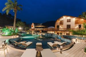a resort with a swimming pool at night at Latauli Sanctuary in Upardāng Garhi