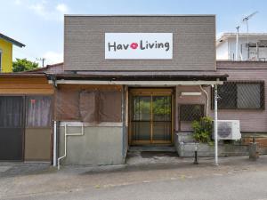 a building with a sign that reads have a living at Hav Living in Oshima