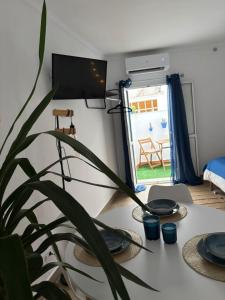 a room with a table with plates and a plant at Alaire Alojamiento in Algodonales