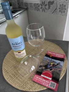 a bottle of wine and a glass on a table at Alaire Alojamiento in Algodonales +2 photos
