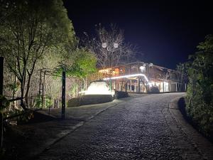 a street at night with a building with lights at Nest hill retreat in Mù Cang Chải