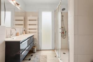a white bathroom with a sink and a shower at Villa Artemis piscine Golfe St-Trop in Grimaud +33 photos