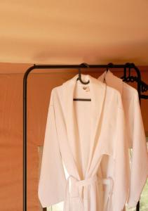 a white shirt hanging on a rack at Yagoda Moya in Khot +37 photos