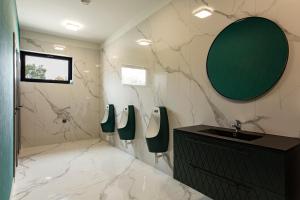 a bathroom with three urinals and a sink at Mayor Pension in Komárno +21 photos
