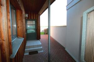 a hallway of a house with a door and stairs at FERIENHAUS SEENSUCHT in Malchow