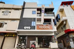 a building with a motorcycle parked in front of it at Hotel O by OYO Sawariya Regency in Bhopal +17 photos